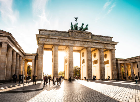 Sun shining through Brandenburg Gate in Berlin